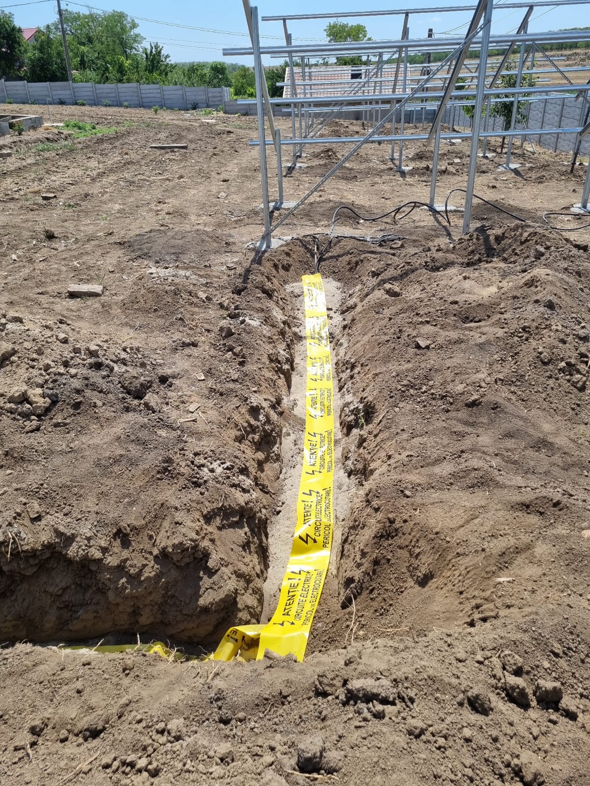Traseu cablu subteran cu bandă de avertizare — sistem fotovoltaic ground-mount
